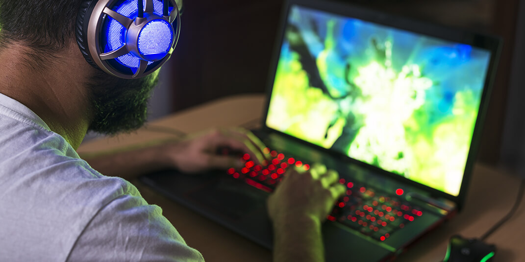 Gamer playing on a gaming laptop