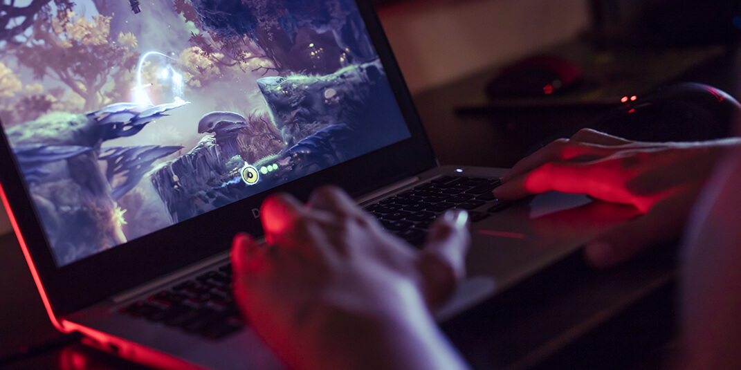 Gamer playing on laptop