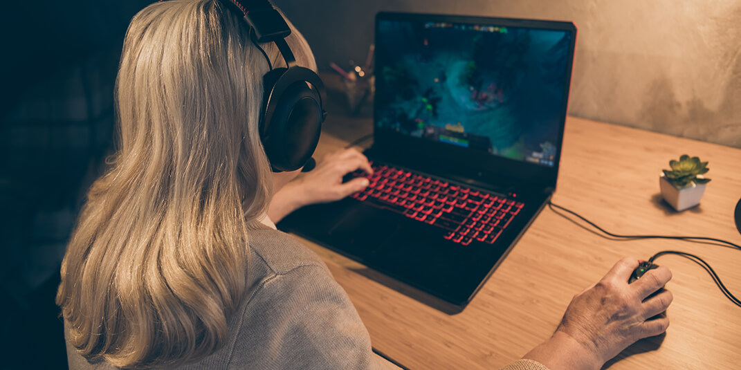 Gaming girl playing a game on her laptop