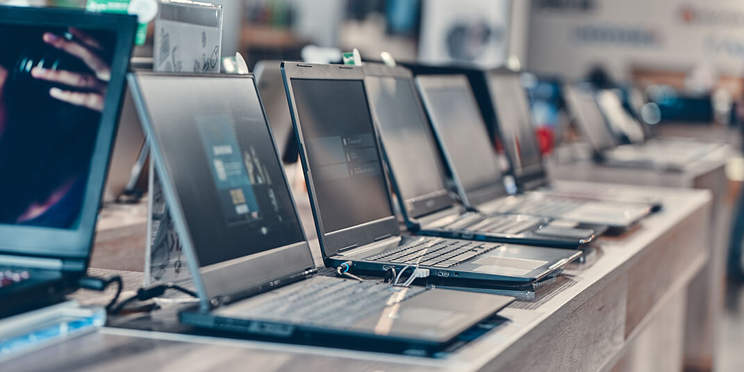 Laptops lined up on a bench